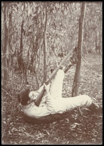 Original caption: 'A favourite pose when shooting koalas ("native bears") in the bush' approx. 1900-1912 Source CG Lane State Library Victoria